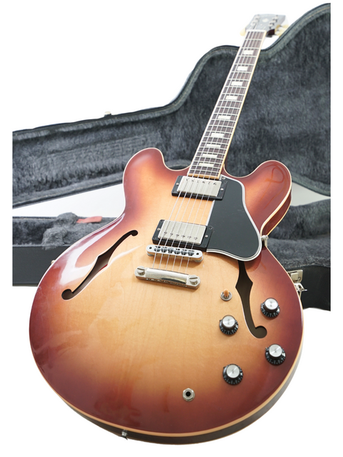 A sunburst-finished Gibson Custom ES-335 guitar from 2012, displayed in its case, highlighting its craftsmanship.