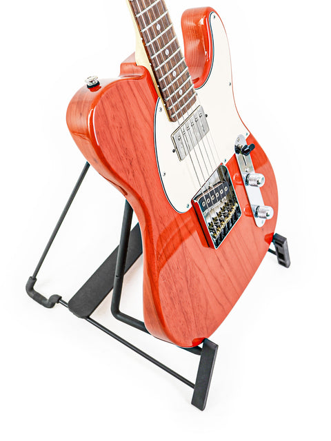 A vibrant red G&L Fullerton Deluxe ASAT Classic Bluesboy guitar positioned on a black stand, emphasizing its stylish appearance.