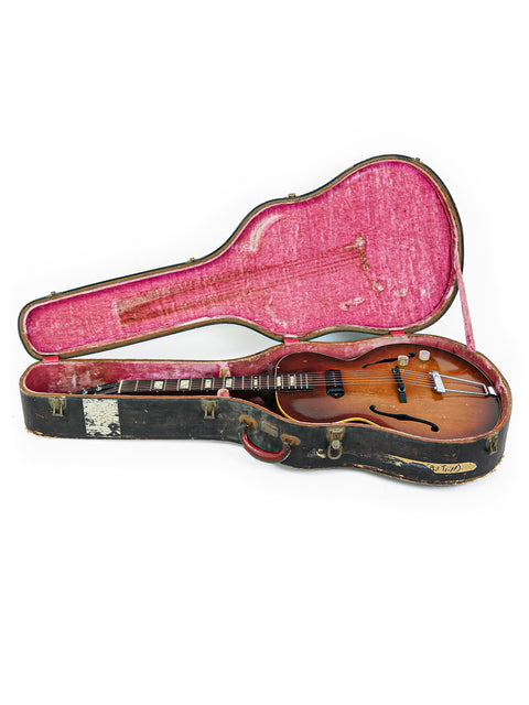 A vintage 1920s Gibson ES-125 mandolin resting in its case, a stunning example of musical heritage and design.