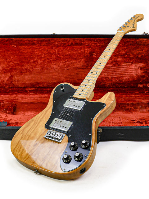 A vintage 1973 Fender Telecaster Deluxe guitar in its case, emphasizing the exquisite craftsmanship of its wooden body.
