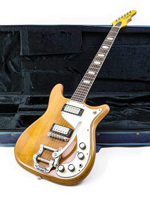 A vintage Epiphone Crestwood Custom guitar from 1964, safely stored in a case, displaying its elegant wooden design.