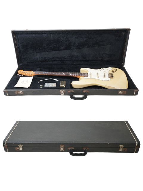 A white Fender Custom Shop '59 Stratocaster Reissue guitar resting in its protective case.