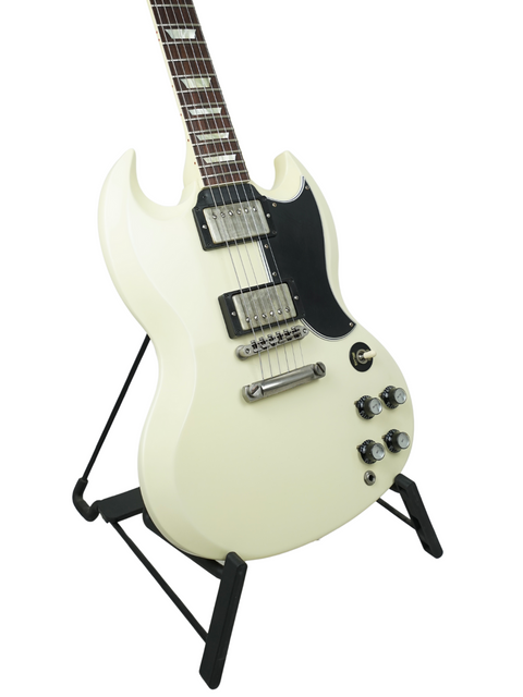 A white electric guitar on a stand, featuring the Gibson Custom Shop Les Paul SG Standard model from the USA, 2014.