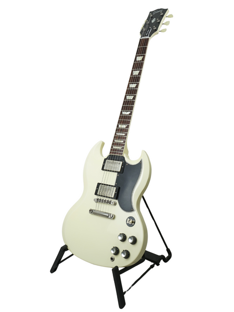 A white electric guitar, the Gibson Custom Shop Les Paul SG Standard from 2014, elegantly positioned on a stand.