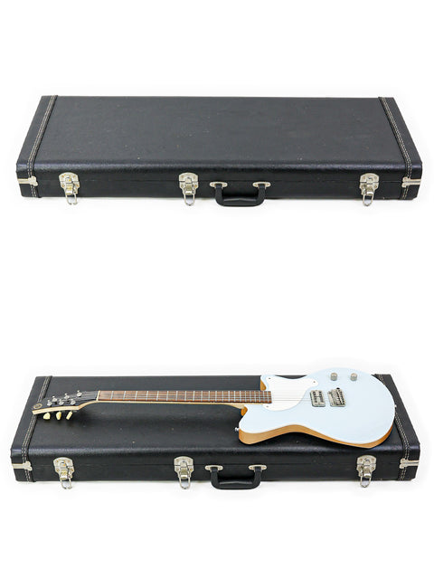 A white guitar case with a contrasting black handle, identified as 'Koll Troubadour - USA 2013', emphasizing its stylish appearance.