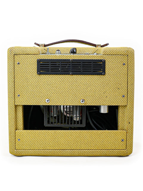 A yellow Fender Custom Shop '57 Champ Combo guitar amplifier with a brown handle, showcasing its vintage design from 2009.