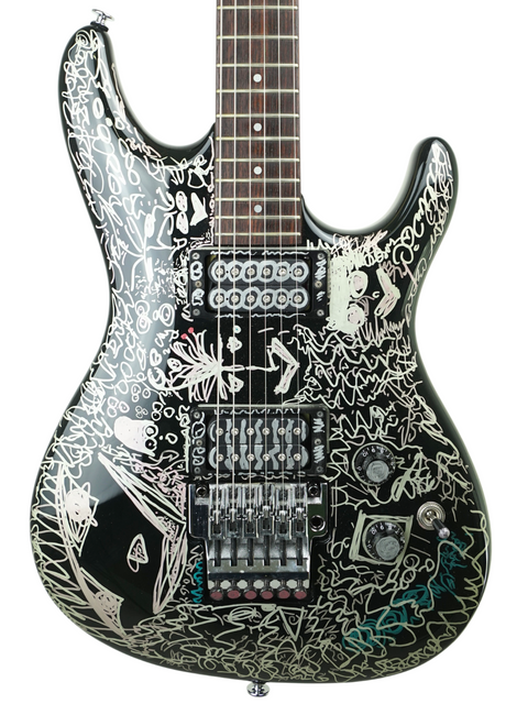 An Ibanez Limited Edition Joe Satriani Black Dog guitar, adorned with vibrant graffiti, highlighting its artistic flair.