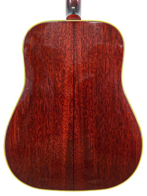 Back of a vintage 1964 Gibson Southern Jumbo acoustic guitar, highlighted by its unique red and yellow color scheme.
