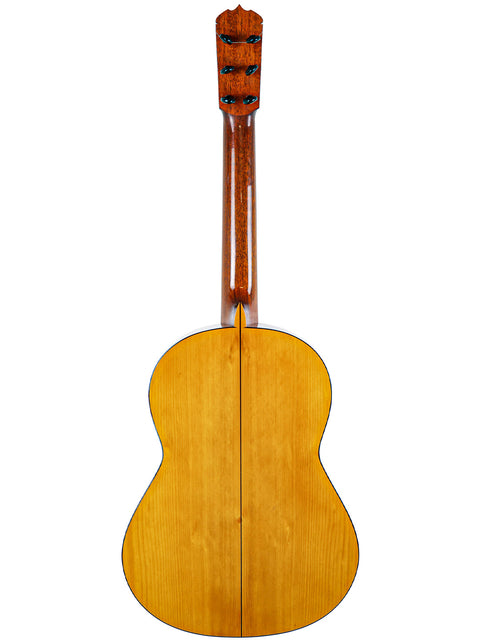 Back view of a 1963 José Ramírez 2A acoustic guitar, showcasing its elegant wooden back and craftsmanship.