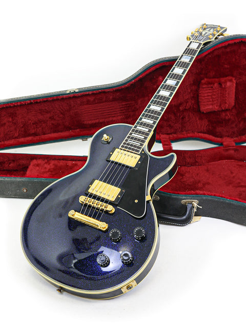 Black Gibson Les Paul Custom electric guitar in a case, showcasing its classic design and craftsmanship from 1991.