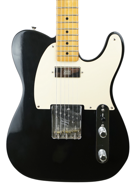 Black and white electric guitar with a maple neck isolated on a white background.