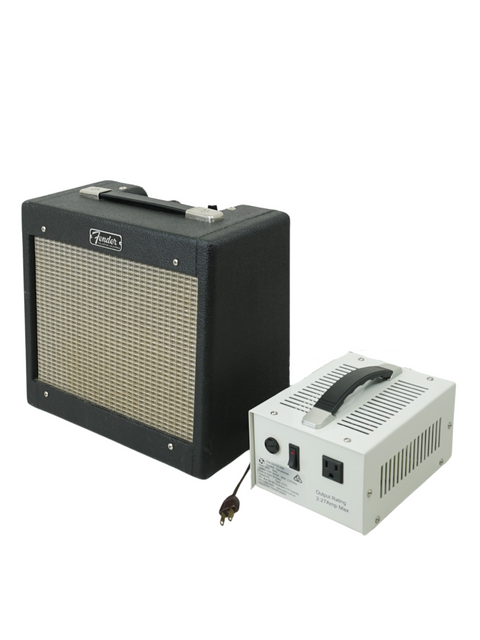 Black and white image of a 1964 Fender Champ 5F1 combo amp with its power supply, showcasing vintage style.