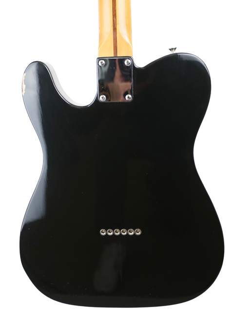 Black electric guitar body with neck and six bridge pins, isolated on white background.