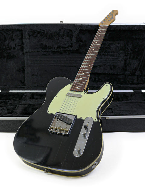 Black electric guitar in a case, showcasing the Fender John English Master Built '59 Custom Telecaster, NRG Special Release.