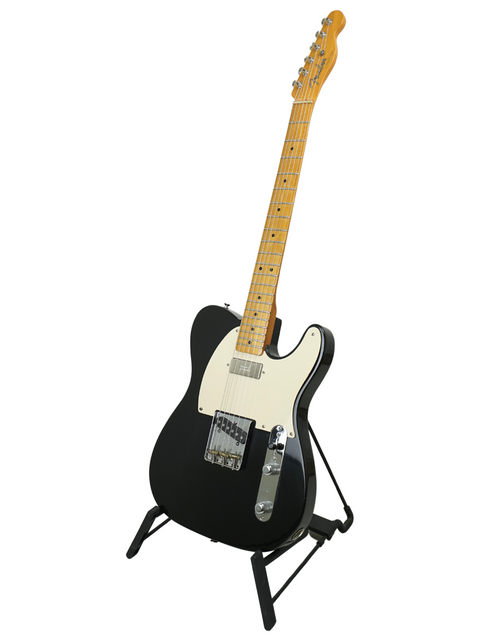 Black electric guitar with maple neck on stand, white background.