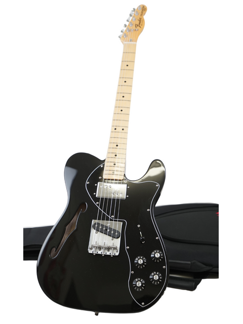 Black electric guitar with white pickguard and maple neck on a stand.