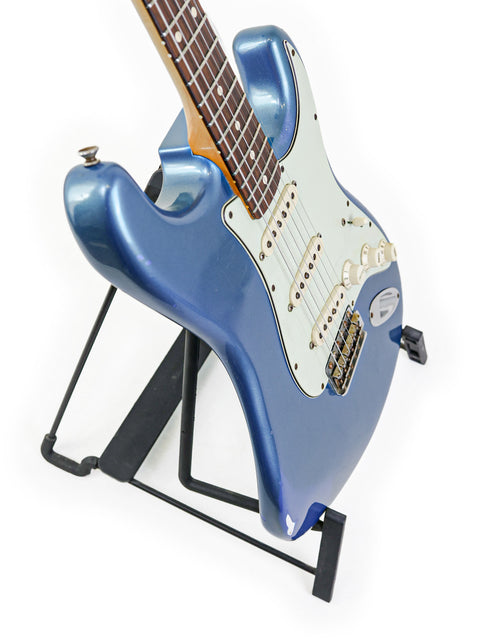 Blue Fender Custom Shop ‘Time Machine’ '62 Stratocaster Relic guitar on a stand, emphasizing its unique relic features.