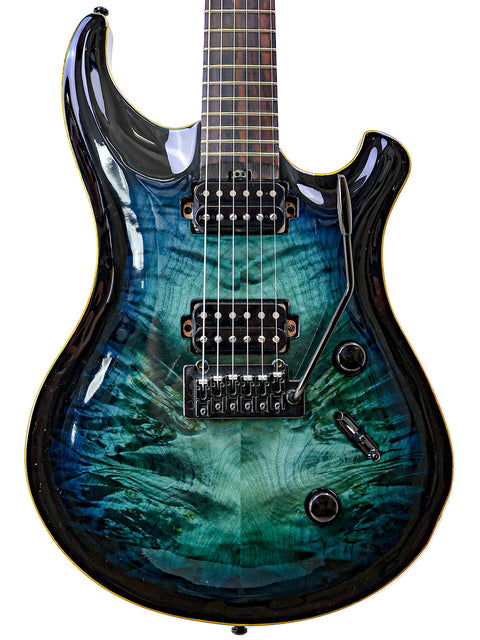Blue electric guitar featuring a black body, model Orthius Deluxe DC, displayed at an event in Australia, 2018.
