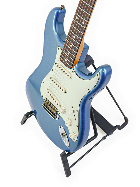 Blue electric guitar on a stand, a Fender Custom Shop ‘Time Machine’ '62 Stratocaster Relic from 2009.