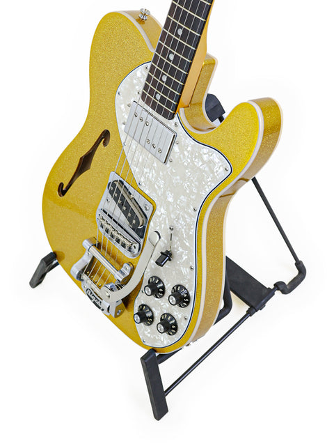 Bright yellow guitar on a stand, set against a clean white backdrop, featuring the Txxx Custom Thinline '72 Partscaster.