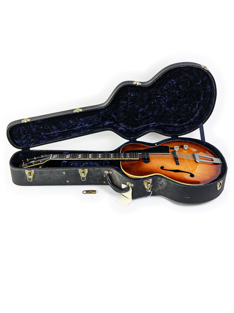 Classic 1946 Gibson ES-300 guitar in its case, set on a bright white background, highlighting its vintage charm.