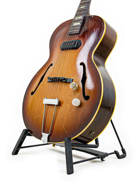 Classic 1948-52 Gibson ES-125 guitar on a stand, highlighted by a simple white background for a timeless look.