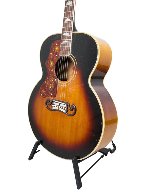 Classic 1955 Gibson J-200 Left-Handed guitar in sunburst finish, beautifully positioned on a stand for display.