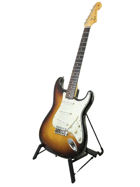 Classic 1959 Fender Stratocaster displayed on a stand, set against a pristine white background for a timeless look.