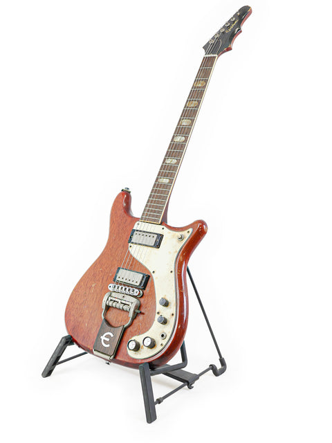 Classic 1966 Epiphone Crestwood Custom guitar resting on a stand, featuring a simple white background.