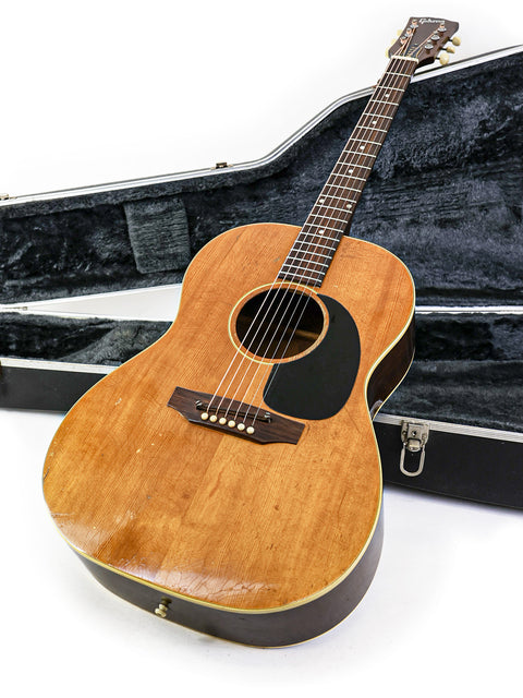 Classic 1968 Gibson B-25N 'Betty' guitar in a case, elegantly displayed on a bright white background.