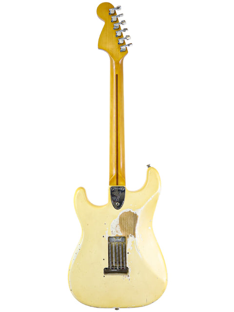 Classic 1974 Fender Stratocaster in yellow with a white body and neck, showcasing a timeless design for music aficionados.