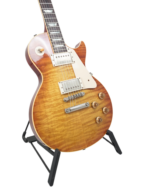 Classic Gibson Les Paul '59 Reissue guitar on a stand, featuring a Brazilian board, ideal for music lovers, against a white background.