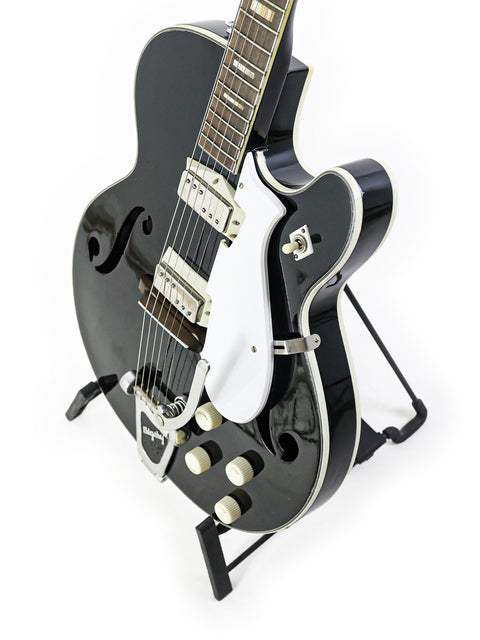 Classic black guitar with a white pickguard, the Silvertone 1446 from 1961-65, perfect for any music lover.