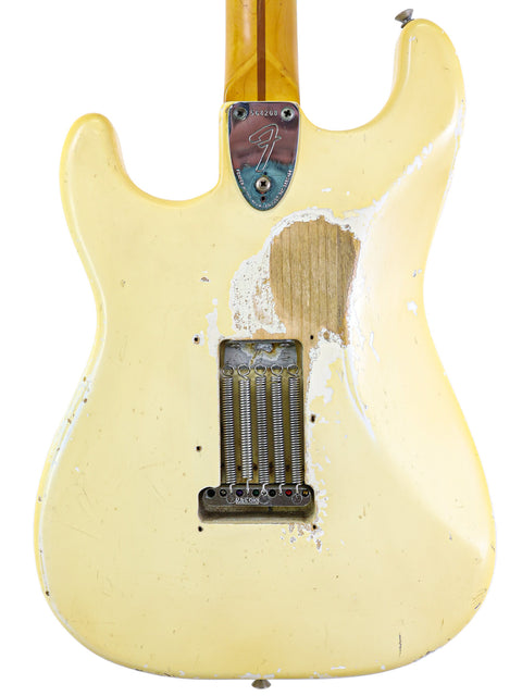 Classic yellow Fender Stratocaster from 1974, with a beautifully crafted wooden body and neck, perfect for any musician.