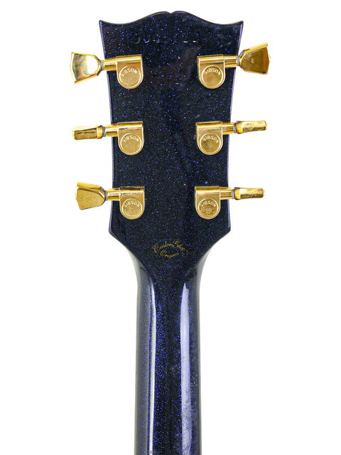 Close-up image of the headstock on a 1991 Gibson Custom Shop Les Paul Custom electric guitar, emphasizing its quality and style.