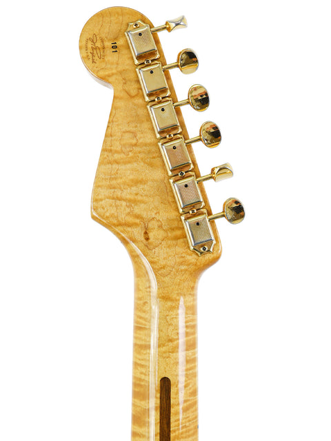Close-up of a 1992 Fender 'Clapton' Stratocaster guitar head, featuring a beautifully crafted wooden body.