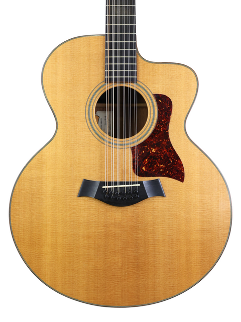 Close-up of a 1995 Taylor LKSM Leo Kottke 12-string guitar, highlighting its elegant design and stunning wood finish.