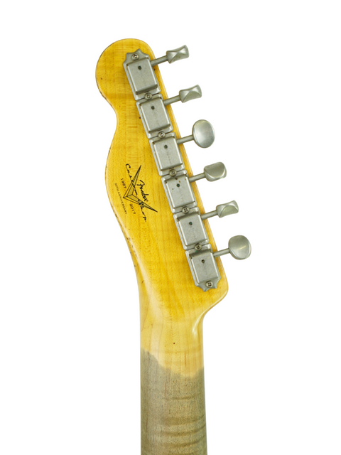 Close-up of a Fender Custom Shop Telecaster guitar head with a yellow body, showcasing its aged relic finish.