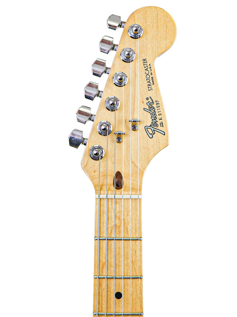 Close-up of a Fender Stratocaster guitar headstock and neck, isolated on white background.