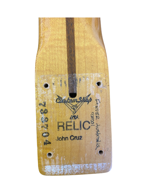 Close-up of a wooden guitar with the Fender Custom Shop name, highlighting the 1998 Cunetto Nocaster Relic model.