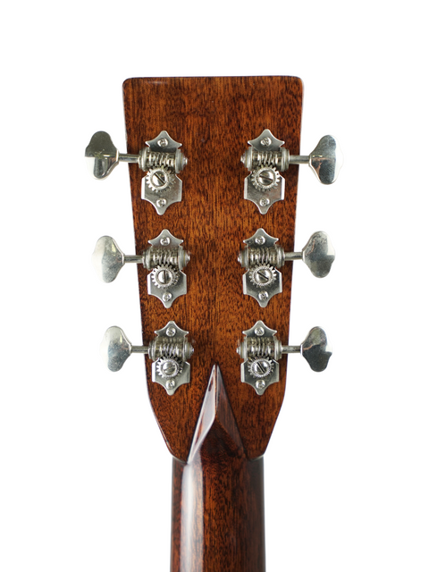 Close-up of guitar headstock with tuning pegs on a white background.