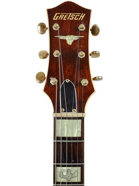 Close-up of the headstock from a 1955 Vintage Gretsch 6130 Roundup electric guitar, showcasing a gold logo.