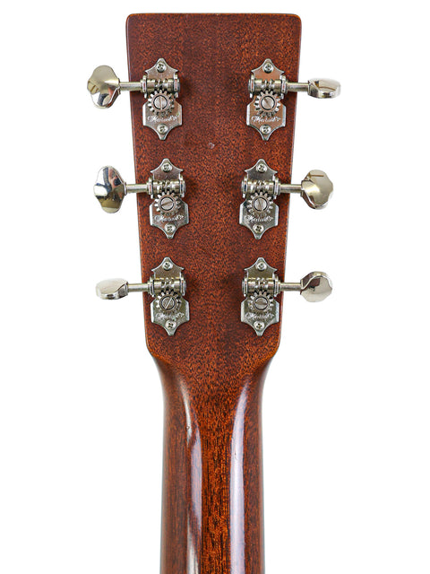 Close-up of the headstock of a Martin D-18 acoustic guitar, showcasing its elegant design and craftsmanship from 2012.