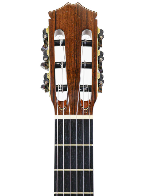 Close-up of the neck of a 2002 Robin Moyes Custom acoustic guitar from Australia, highlighting its fine woodwork and smooth finish.