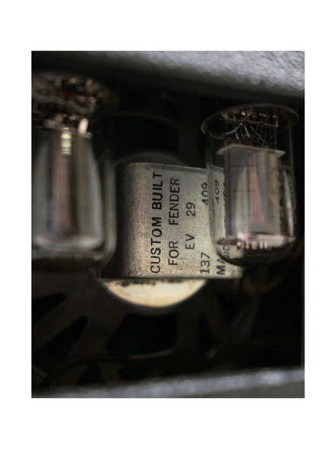 Close-up shot of a 1964 Fender Champ 5F1 combo, highlighting a metal box containing two tubes.