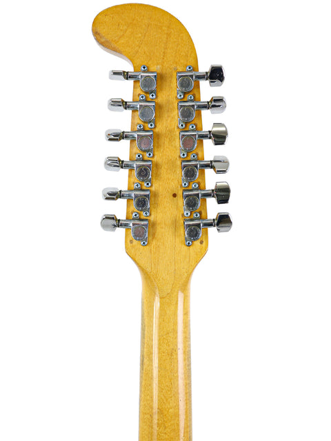 Close-up shot of a vintage 1966 Fender Electric XII guitar head, focusing on the strings and iconic design elements.