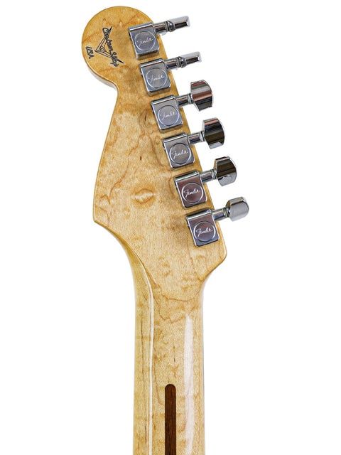 Detailed view of a 1994 Fender Custom Shop Stratocaster guitar head, highlighting the wooden body and craftsmanship.