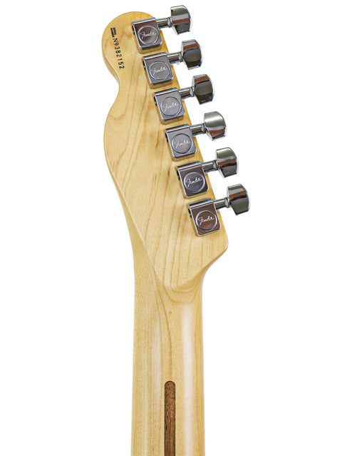 Detailed view of a 1999 Fender Tele Plus V2 guitar head, highlighting the wooden body and tuning mechanisms.