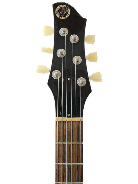 Detailed view of a Koll Troubadour electric guitar, highlighting its features on a bright white background for clarity.