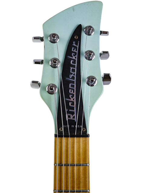 Detailed view of a Rickenbacker 650C headstock from 2005, prominently displaying the word "bucker" in an elegant font.